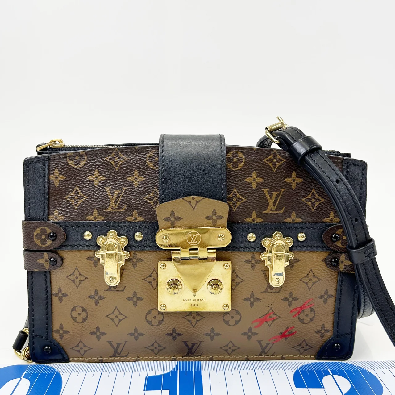 LV MONOGRAM REVERSE TRUNK CLUTCH